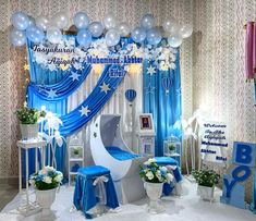 a blue and white themed birthday party with balloons, streamers, flowers, and decorations