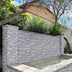 an outdoor hot tub surrounded by trees and bushes