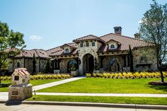 a large house with lots of windows and landscaping