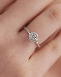 a woman's hand with a diamond ring on it