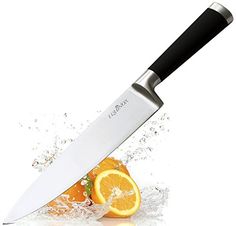 an orange being sliced in half with a knife sticking out of it's side