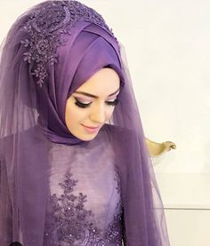 a woman wearing a purple hijab and veil