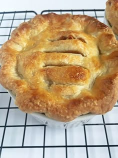 two pies sitting on top of a cooling rack