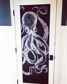 an octopus drawn on a door with chalk