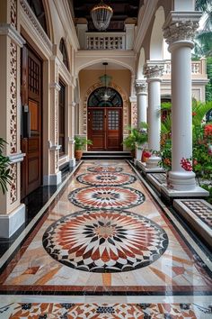 an elaborately decorated hallway with columns and flowers on the floor is pictured in this image