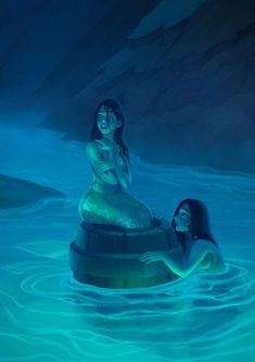 two mermaids are sitting in the water together