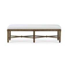 a wooden bench with white upholstered cushion on it's back and legs