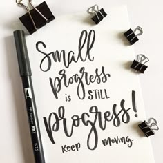 small progress is still progress keep moving quote on white paper with black clippings