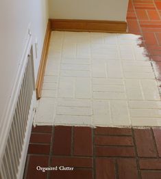 the floor is being painted and ready to be installed in the kitchen area with red brick