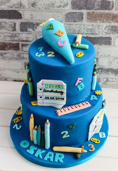 a blue cake with school supplies on it