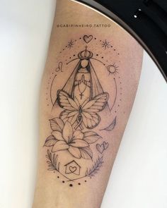 a woman's leg with a butterfly and flower tattoo design on the left calf