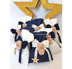 the teddy bears are wrapped in blue and white fabric with gold glitter stars on top