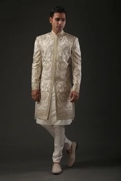 Ivory matka silk sherwani with zari and hand embroidery in floral motifs and silk lined.
Component: 1
Pattern: Embroidered
Type Of Work: Zari
Neckline: Mandarin
Sleeve Type: Full
Fabric: Matka Silk, Lining: Silk 
Color: Ivory
Other Details: 
Zari work
Note: Pant and inner kurta worn by the model is not for sale
Occasion: Groom,Wedding - Aza Fashions Cream Sherwani, Seema Gujral, Sherwani For Men Wedding, Modern Indian Wedding, Sherwani Groom, Kurta Cotton, Mens Sherwani, Sherwani For Men, Rohit Bal