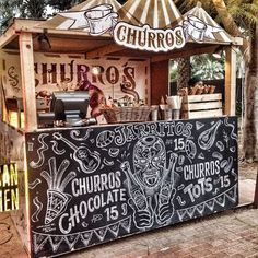 a food stand with chalk writing on it