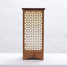 a tall wooden screen sitting on top of a table