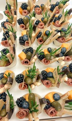 a table topped with lots of different types of fruit and veggies on skewers