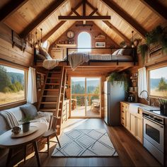 a loft with stairs leading up to the bed and kitchen area in front of it