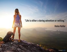 a woman standing on top of a mountain next to a backpack with the quote life is either a daring adventure or nothing