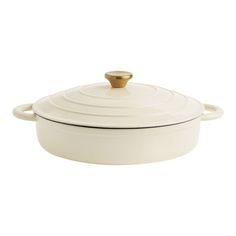 a white casserole dish with a gold lid