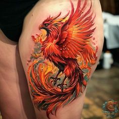 a woman's thigh with an orange and red bird on it