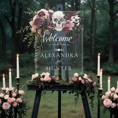 a welcome sign surrounded by candles and flowers