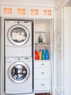 a washer and dryer are in the closet next to each other with bottles