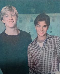 two young men standing next to each other