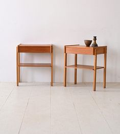 two small wooden tables sitting next to each other