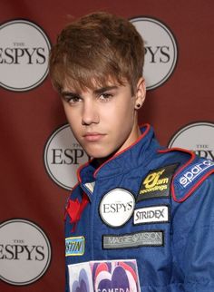 a young man in a racing suit posing for a photo at an espy's event