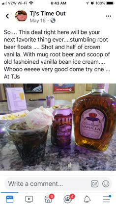 a bottle of ice cream sitting on top of a counter next to a cup filled with liquid