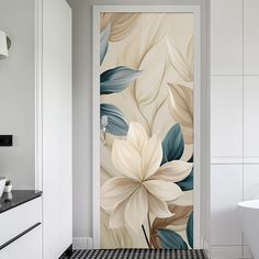 an open door in a white bathroom with flowers painted on the wall and black tile flooring