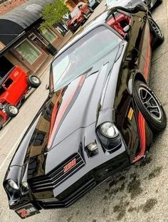 a black and red car parked on the street