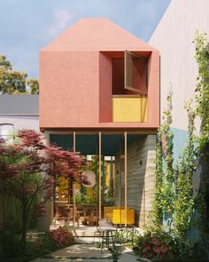 a pink house with an open window in the middle of it's garden area