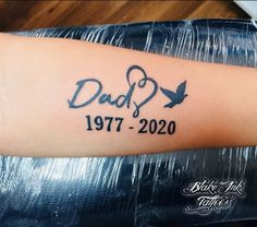 a tattoo on the arm of a person with a heart and an arrow that reads dad 1971 - 2020