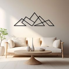 a modern living room with white furniture and mountains on the wall above the coffee table