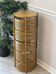 a round wooden stand next to a potted plant