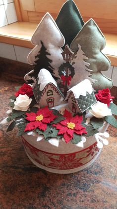 a christmas tree made out of fabric and felt with poinsettis on top