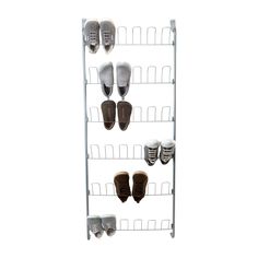 several pairs of shoes are hanging on a metal rack in front of a white background