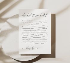 a paper with the words bride and groom written on it next to a white plate