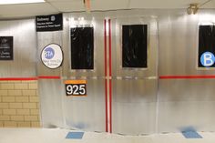 an empty subway station with signs on the wall and doors that say 925 b st