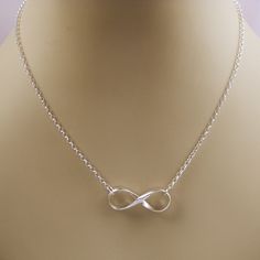 "Elegant sterling silver infinity necklace! The silver infinity symbol was hand forged from a heavy half round wire and polished to a high shine. The infinity symbol hangs from a nice medium weight rolo chain. All jump rings are soldered closed. Perfect gift to show your everlasting love for that special someone! Material: 925 sterling silver Infinity Pendant Measurement: 1\" long Necklace Length: 18 inches with a EZ handle spring clasp * Please read my shop policies for shipping and additional Silver Infinity Necklace, Symbol Jewelry, Infinity Necklace Silver, Necklace Infinity, Infinity Pendant, Hammered Rings, Infinity Necklace, Infinity Symbol, The Infinity