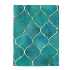 a blue and gold tile with an intricate design on the bottom, in shades of teal