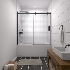 a white bathroom with black and white tile flooring