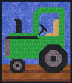 a green tractor quilted on top of a blue background with an arrow in the center