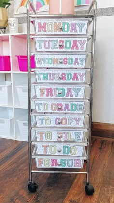 a metal rack with lots of cards on top of it in front of a wall