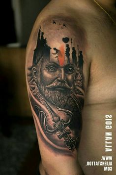 a man's arm with a tattoo on it that has an image of a bearded man