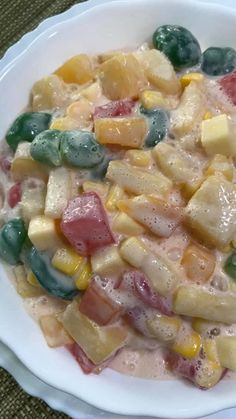 a white bowl filled with lots of different types of food on top of a table