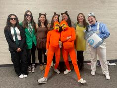 a group of people in costumes posing for a photo