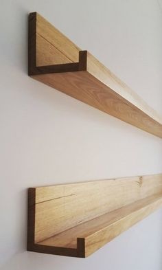 two wooden shelves mounted to the side of a wall