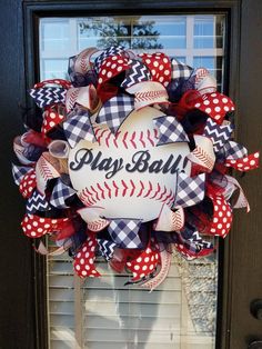 a baseball wreath with the words may ball on it and red, white and blue bows